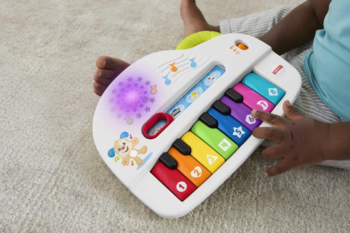 Produktbild Fisher-Price Doggie Piano Laugh & Learn Multilingual Edition, tragbar mit Lichtern, Strophen d