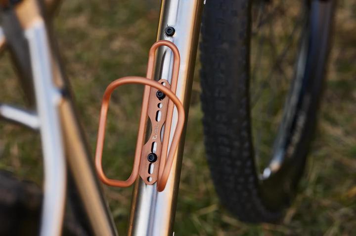 Actual product image Wolf Tooth Morse bottle cage, titanium, limited copper