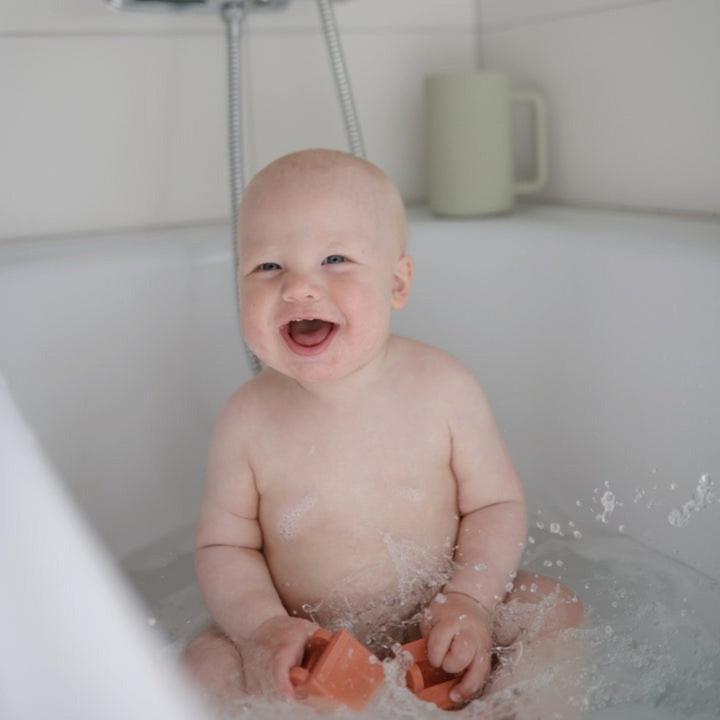 Actual product image Mushie Bath play set vehicles
